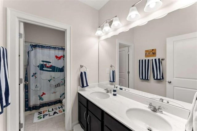 bathroom with double vanity, a sink, tile patterned floors, and a shower with shower curtain