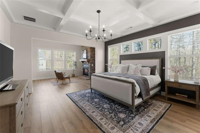 bedroom featuring wood finished floors, multiple windows, and visible vents