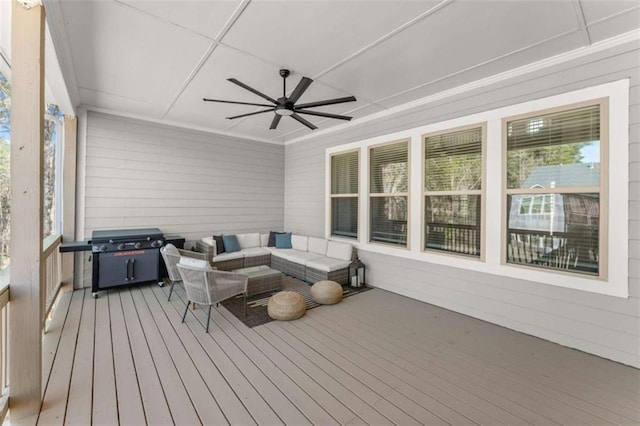 wooden terrace with outdoor lounge area, a grill, and a ceiling fan