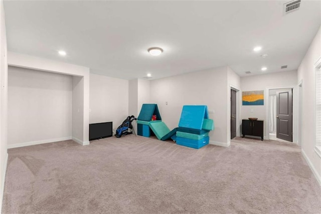 living area featuring carpet floors, baseboards, and visible vents