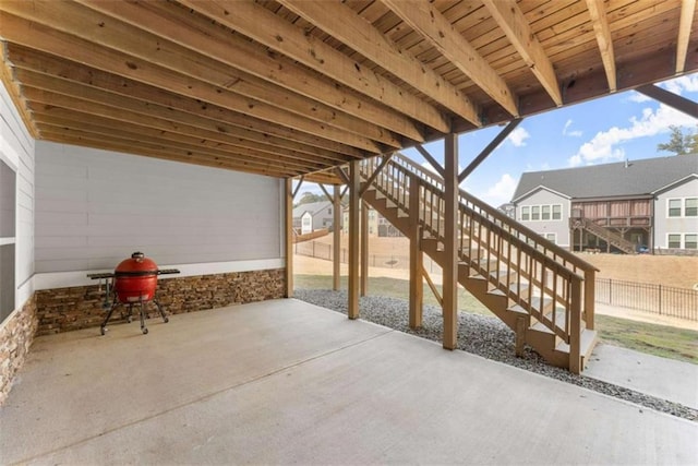 view of patio / terrace with fence and stairway