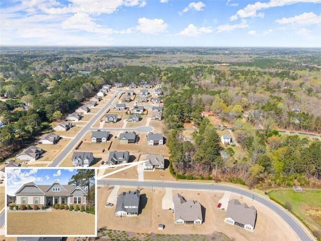 birds eye view of property with a residential view