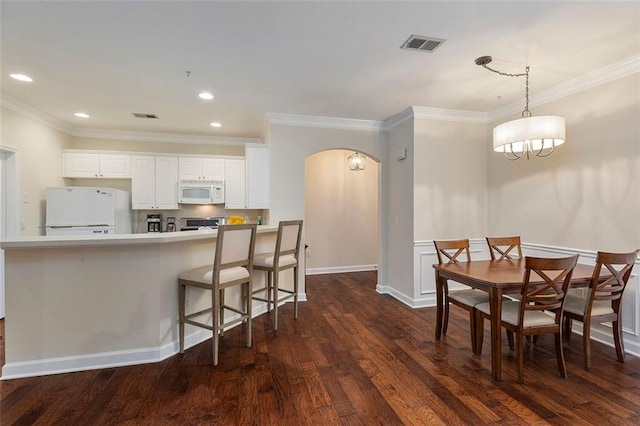 2400 Cumberland Pkwy SE Unit 613, Atlanta, GA 30339 - dining room with dark wood-style floors, arched walkways, crown molding, recessed lighting, and a chandelier
