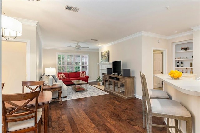 2400 Cumberland Pkwy SE Unit 613, Atlanta, GA 30339 - living area with dark wood finished floors, crown molding, ceiling fan, built in shelves, and baseboards