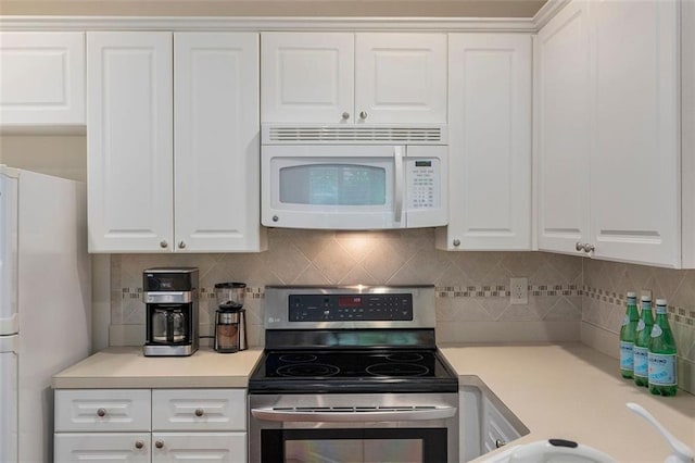 2400 Cumberland Pkwy SE Unit 613, Atlanta, GA 30339 - kitchen featuring white appliances, white cabinetry, decorative backsplash, and light countertops