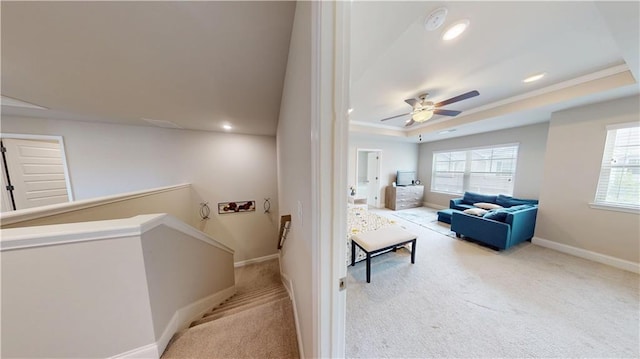 stairs with recessed lighting, a tray ceiling, baseboards, and carpet