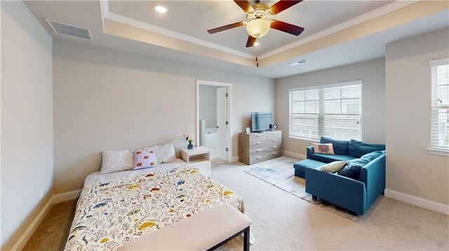 bedroom featuring crown molding, a raised ceiling, visible vents, and carpet