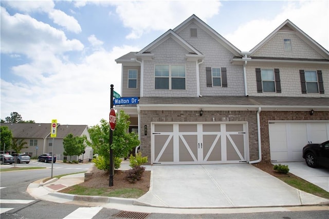 townhome / multi-family property featuring concrete driveway and an attached garage