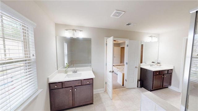 full bathroom with visible vents, a sink, and plenty of natural light