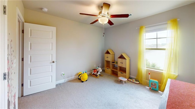 game room featuring carpet flooring, ceiling fan, and baseboards
