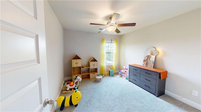 recreation room featuring carpet floors, baseboards, and ceiling fan