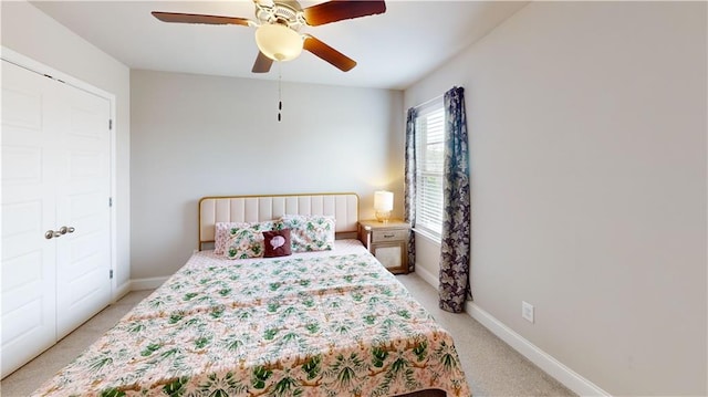 bedroom with baseboards, light carpet, and a ceiling fan