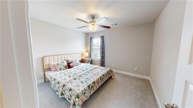 carpeted bedroom featuring baseboards, visible vents, and ceiling fan