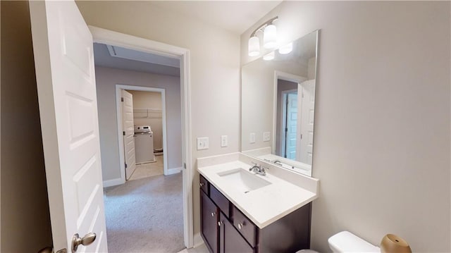 bathroom featuring vanity, baseboards, and toilet