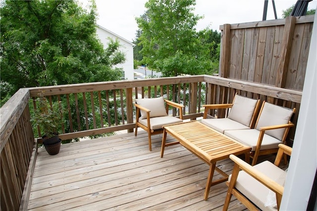 wooden terrace with an outdoor hangout area