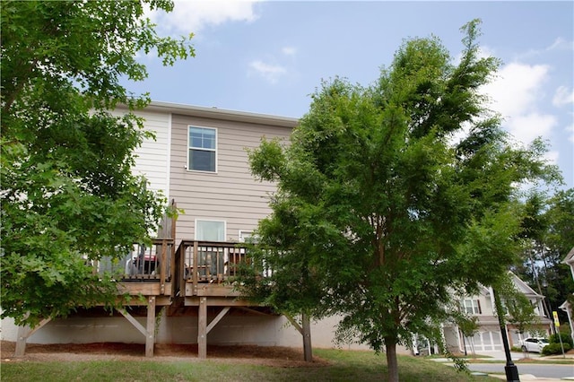 rear view of house featuring a wooden deck