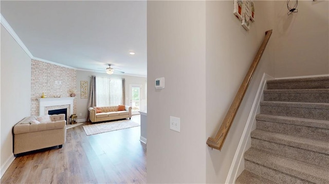 stairway with baseboards, ornamental molding, and wood finished floors