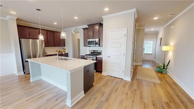 kitchen featuring visible vents, a sink, light wood finished floors, and appliances with stainless steel finishes