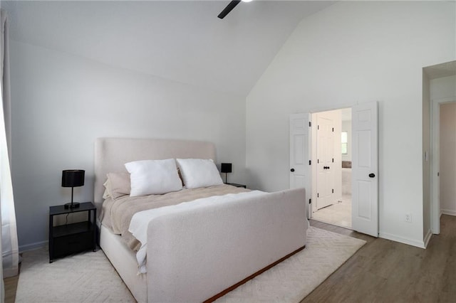 3185 Perch Dr SW, Marietta, GA 30008 - bedroom with wood finished floors, high vaulted ceiling, baseboards, ceiling fan, and ensuite bath