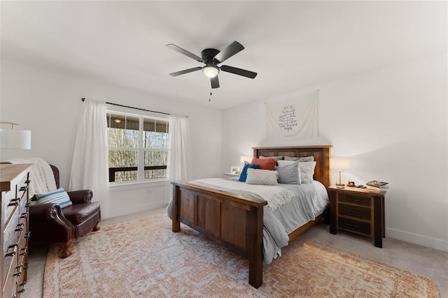 bedroom with light carpet, ceiling fan, and baseboards