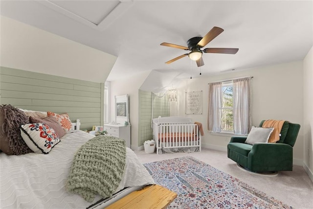 bedroom with baseboards, ceiling fan, attic access, and carpet flooring