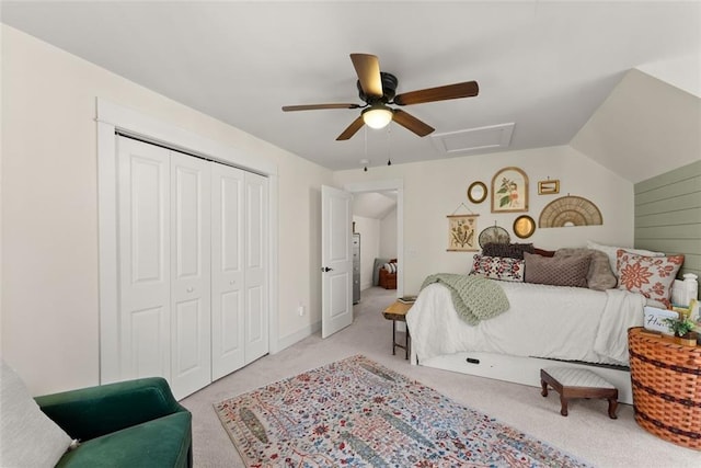 bedroom with a closet, light colored carpet, attic access, ceiling fan, and vaulted ceiling