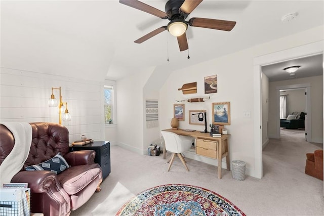 office with a ceiling fan, light carpet, and baseboards