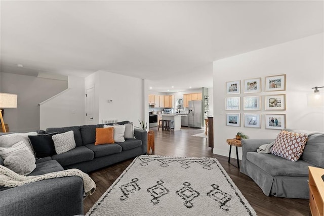 living area featuring dark wood-type flooring and recessed lighting