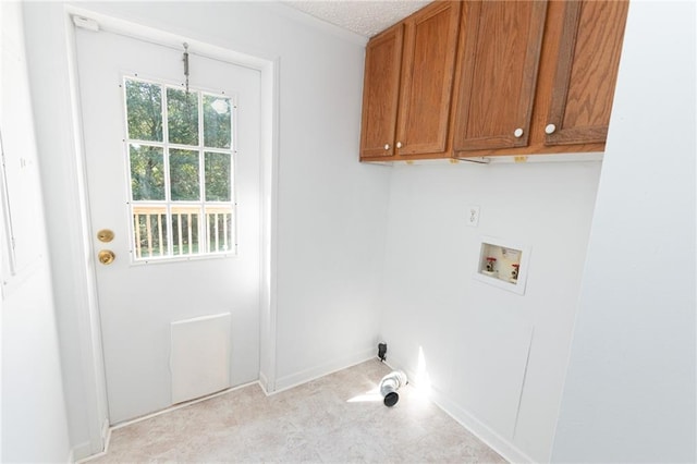 laundry room featuring baseboards, cabinet space, and washer hookup