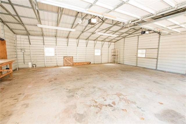 garage featuring metal wall and a garage door opener