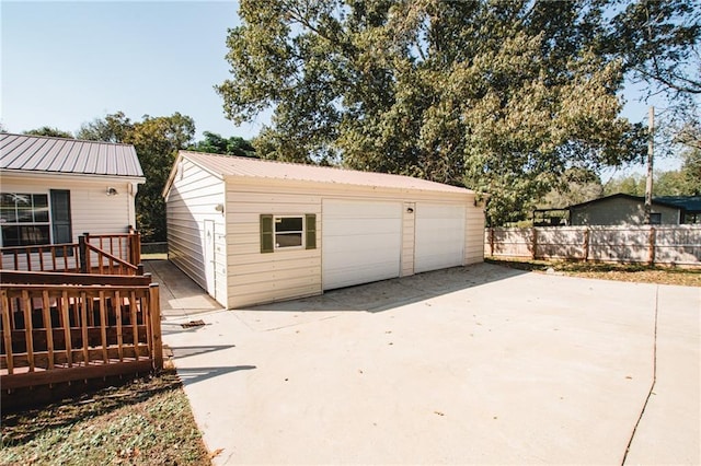 detached garage featuring fence