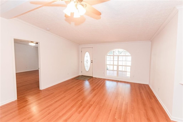 unfurnished room with ornamental molding, a textured ceiling, a ceiling fan, and light wood-style floors