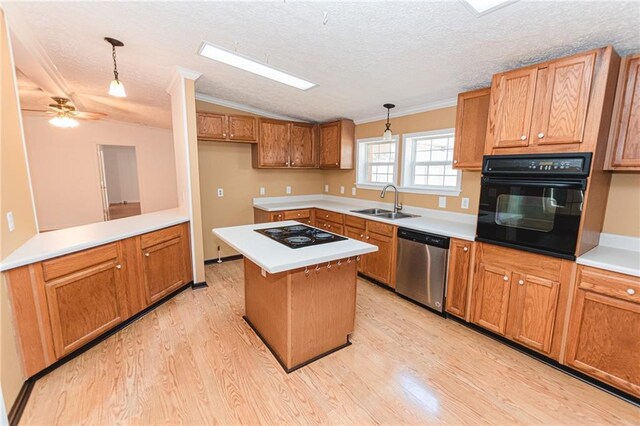 kitchen featuring ornamental molding, light wood-style floors, black appliances, and a sink