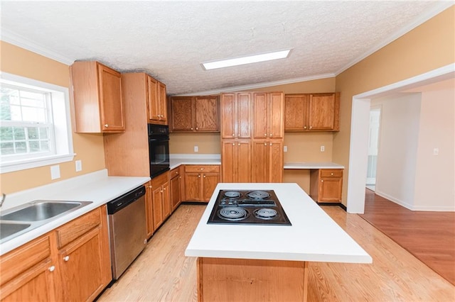 kitchen featuring stainless steel dishwasher, light wood-style flooring, stovetop with downdraft, and oven