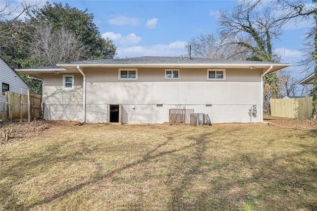 rear view of property with a yard