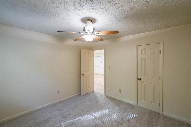 carpeted spare room featuring a textured ceiling