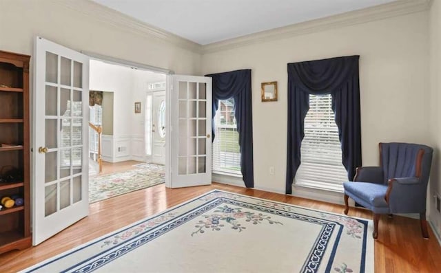 sitting room with french doors, hardwood / wood-style flooring, and ornamental molding