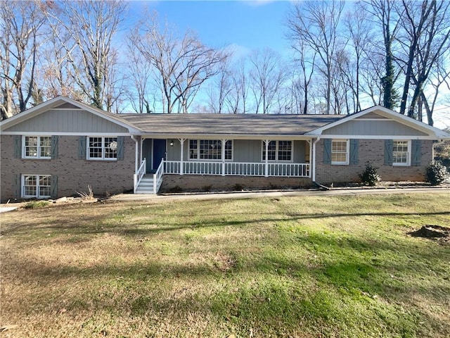 ranch-style house with covered porch and a front lawn