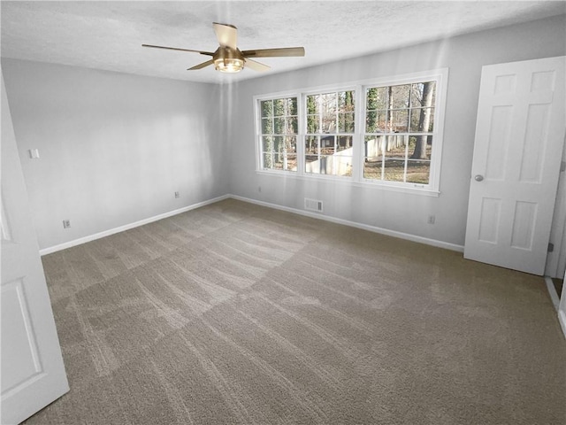 spare room featuring carpet flooring, a textured ceiling, and ceiling fan