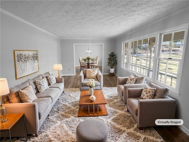 living room featuring crown molding, hardwood / wood-style floors, a textured ceiling, and a notable chandelier