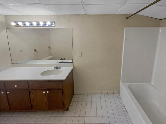 empty room with a paneled ceiling, ceiling fan, and carpet