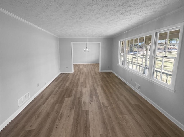 unfurnished room featuring a textured ceiling, dark hardwood / wood-style flooring, and a notable chandelier