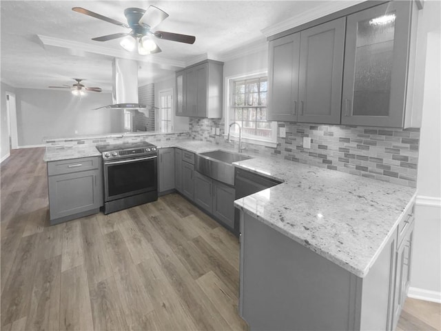 kitchen featuring gray cabinetry, ventilation hood, electric stove, sink, and kitchen peninsula