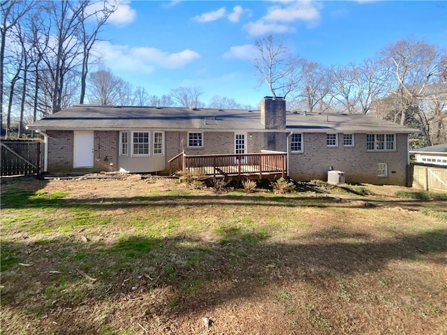 back of house featuring a deck and a yard