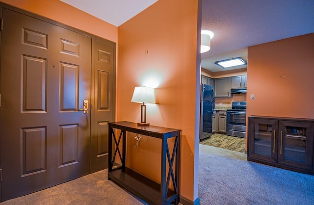 view of carpeted foyer entrance