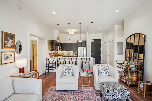 living room featuring dark wood-style floors, electric panel, and recessed lighting