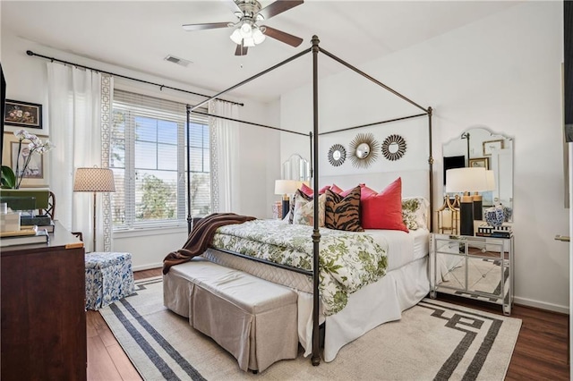 bedroom featuring visible vents, baseboards, and wood finished floors