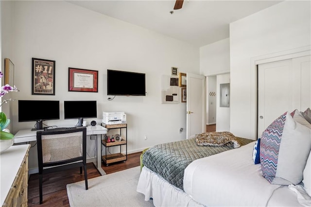 bedroom featuring ceiling fan, a closet, wood finished floors, and baseboards