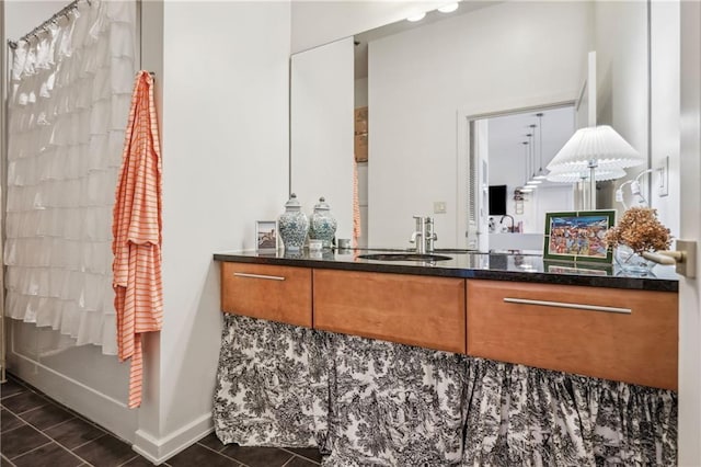 full bath with tile patterned flooring, vanity, and baseboards