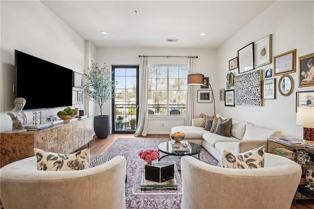 living area featuring wood finished floors and visible vents